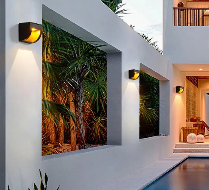Outdoor wall lights washing a façade and garden.
