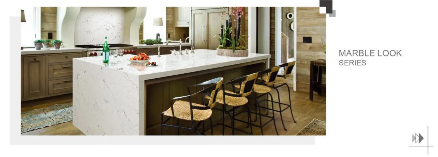 Light stone island with a breakfast bar.