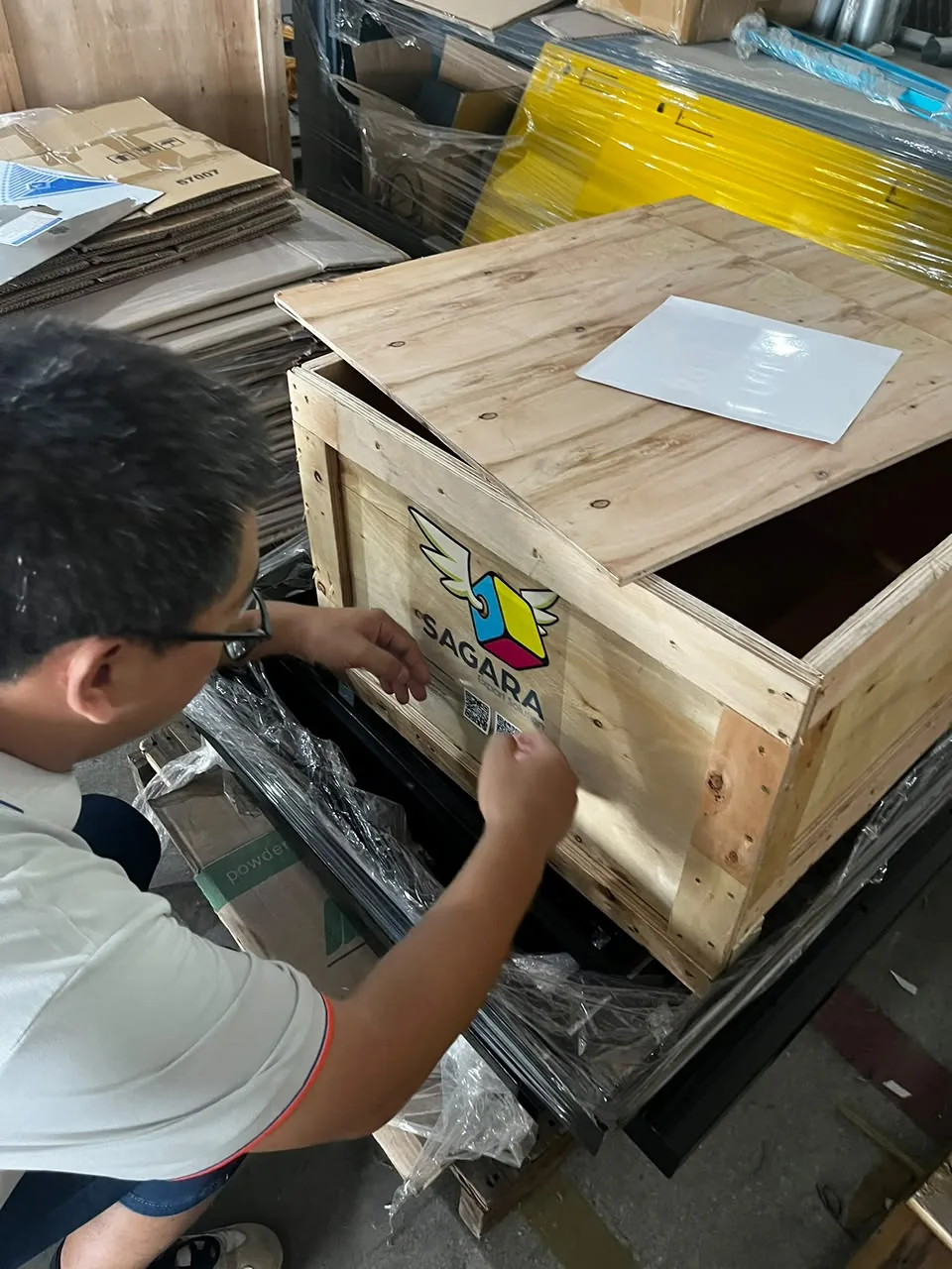 Cierre del huacal de madera, con el logo de SAGARA sellado en la tapa.